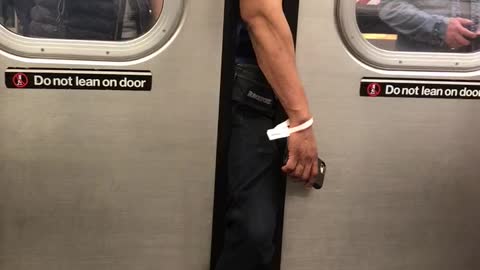 Guy with arm and leg stuck outside of subway door assistance