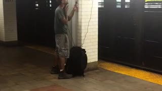 Man shaves on subway station