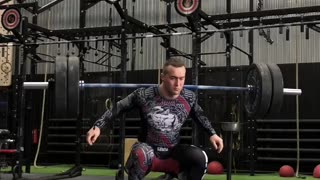 Man Lifts Weights While on Balance Board