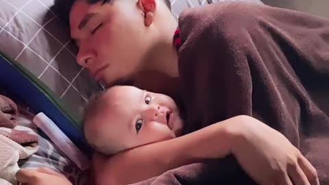 Sleeping Dad Cuddles Infant Daughter