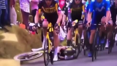 About dozen of cycling boy fell during race by a mistake of single audience