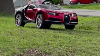 Baby Girl with a Huge Grin Riding in Toy Bugatti