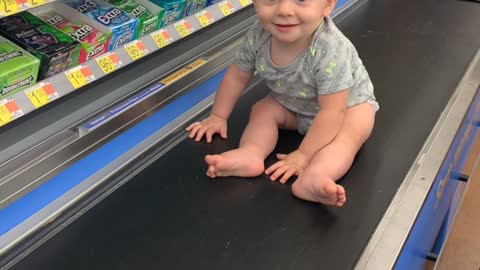 Baby Rides Grocery Conveyer Belt