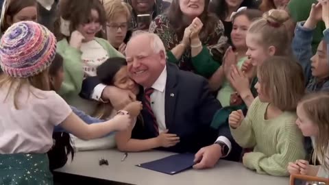 Tim Walz signing a law guaranteeing all students receive a free breakfast