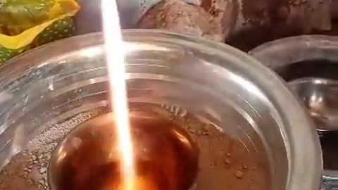 Real Unrefined gold being transformed to refined gold bar
