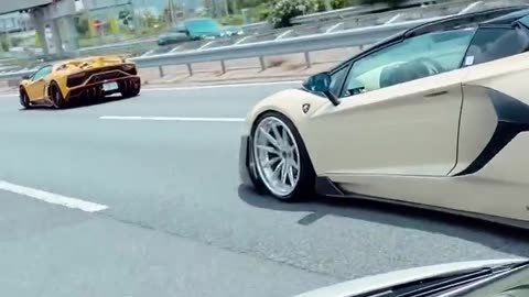 A fleet of Lamborghini cars on the motorway