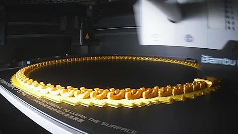 3D printed gold chain on Bambu Lab P1S using a raft.