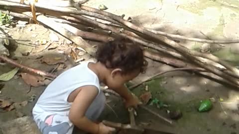 Amazing 2 years old Boy cutting piece of wood using saw