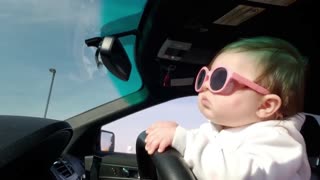 Baby enjoying the car ride, is also enjoying driving