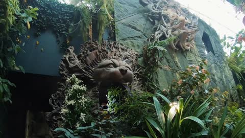 Botanical Garden. Singapore. Stone Statue Of Lion Or Dog