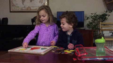 Two Adorable Kids do Puzzle Together