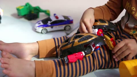 a child's hand playing with a robot toy