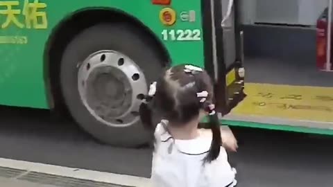 A little girl waited at a bus stop to deliver a surprise drink to her bus driver dad.