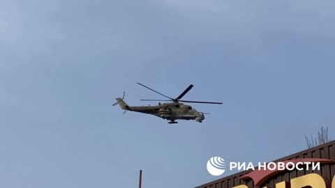 Ukraine war - Mi-24 helicopter flying over the city of Novoazovsk