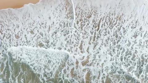 Top View of Sea Waves Crashing on Seashore
