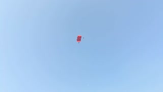 brave parachute jumping on the building