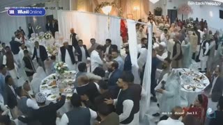 Moment lavish wedding reception descends into a mass brawl as guests punch
