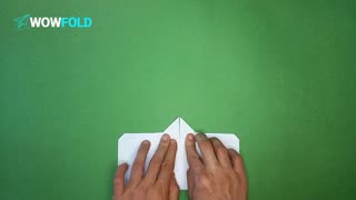 White Cloud - folding a paper airplane