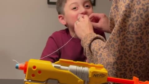 Parents use a Nerf gun to pull kid's tooth