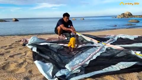 Bibi helps Dad set up a camping tent at the beautiful beach!