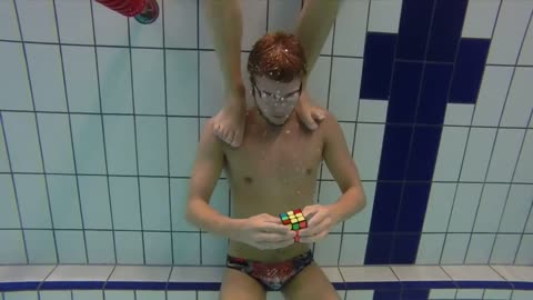 Swimmer solves 3 Rubik's cubes underwater in one breath