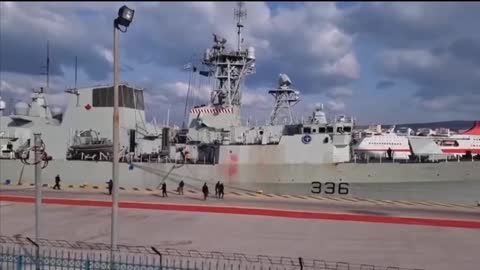 Activists in Greece protest the entry of a NATO ship into the port, throwing red paint