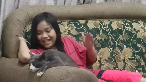 My daughter trying to entertain her bored cat
