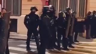 Some police officers in France remove their helmets and stop fighting with protesters.