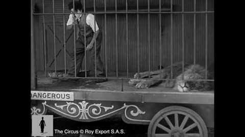 Charlie Chaplin . The lion cage