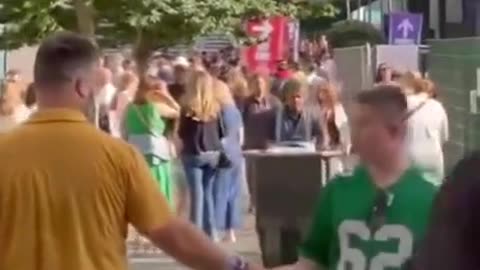 Jason Kelce greets a fan wearing his Eagle jersey in London.