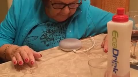 Grandmother learning to use Google Home