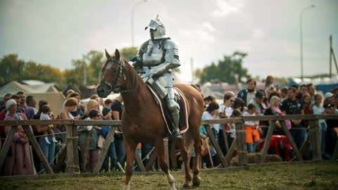 A man knight riding a horse near the fence while the fight tournament