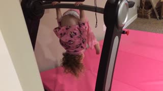 Little girl in pink upside falls on head