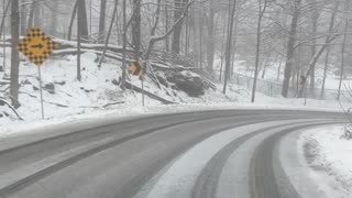 Car Slides Into Snowy Ditch