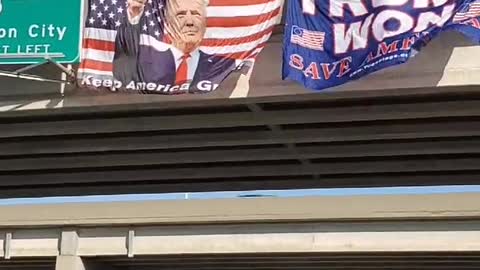 Huge Trump Flags displayed on a Hwy Bridge