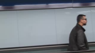 Guy dancing on flat escalator dance backwards