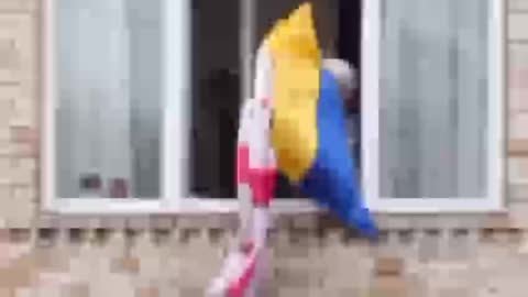 An elderly woman did not allow the guy to hang the flags of Ukraine and Georgia on the window