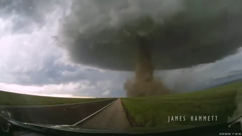 Storm chasing dashcam: Tornado crossing the highway! Laramie, Wyoming