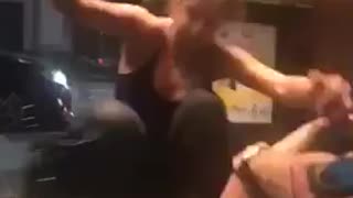 Girl with hair bun falls back on trash can