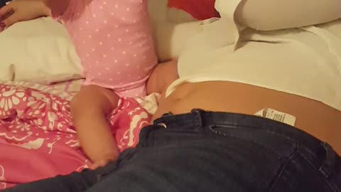 Baby in pink cries when mom laying next to her cries