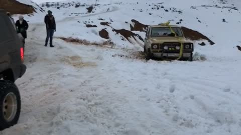 Truck tries to pull stuck car out of ditch with ratchet tie, tie snaps