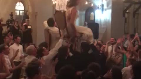 Newlyweds hold on to their chairs!
