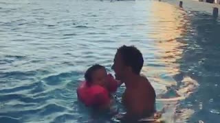 father and his son in swimming pool vacation