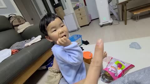 So cute baby eating snacks