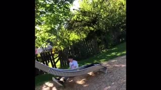 Guy in white shirt falls off silver slide