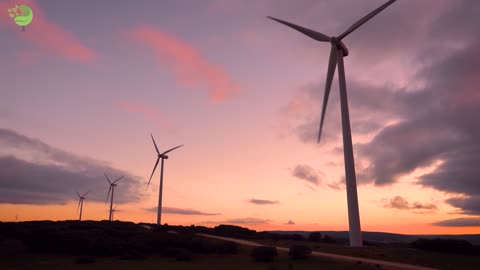 Wind turbine farm on beautiful purple sunset mountain landscape. Renewable