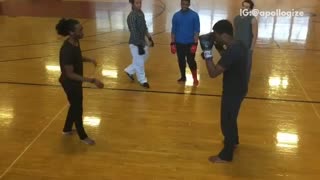 Two guys boxing in basketball court gymnasium