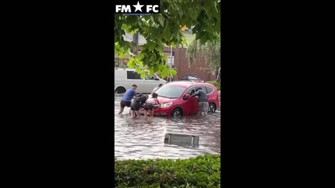 Sudden heavy rainfall forces commuters to push car out of floods