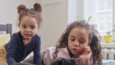 Kids Petting Their Dogs On the Bed