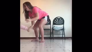 Girl lifts leg of small girl fall